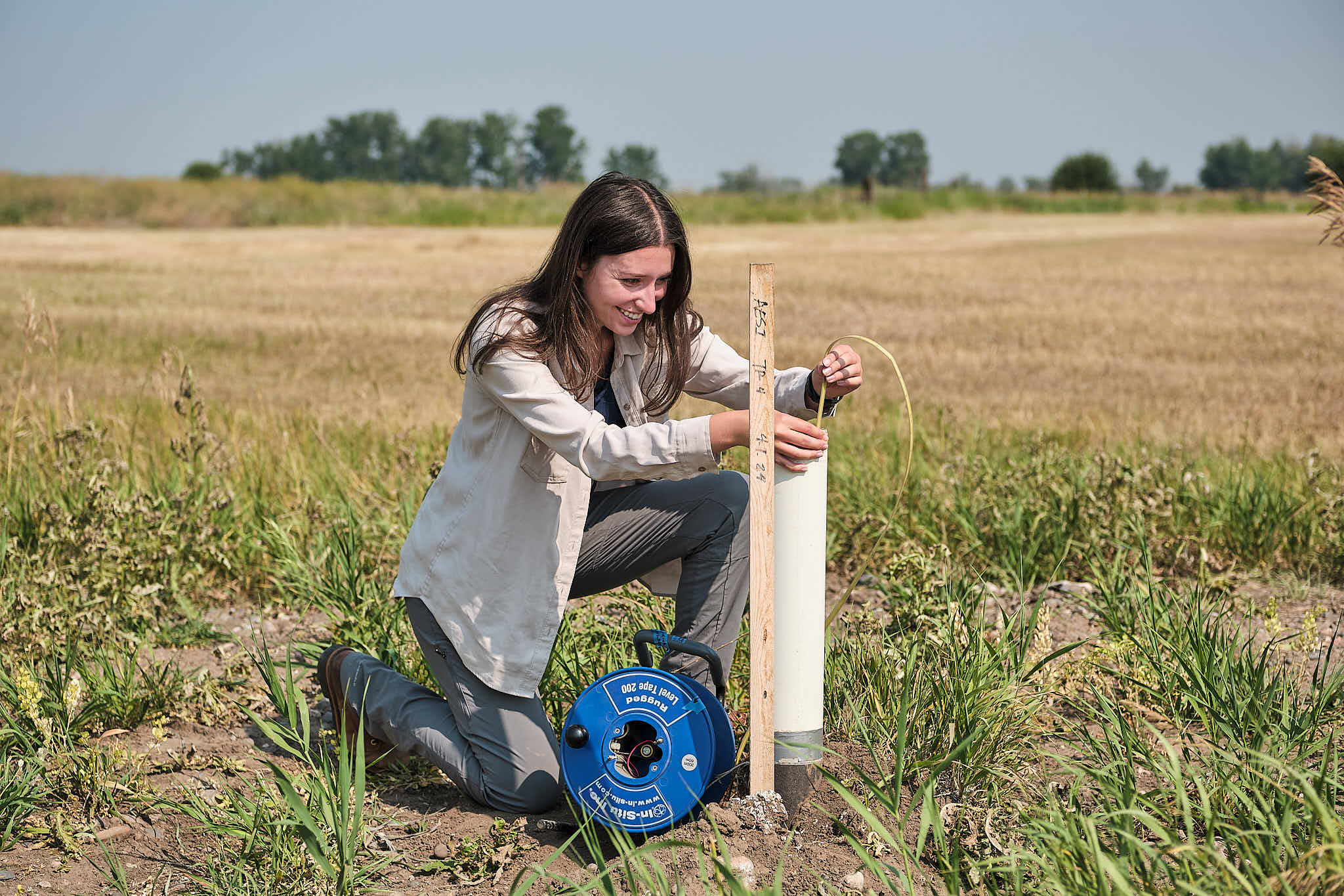 Water resource engineer conducting a well water test in Bozeman, Montana during summer.