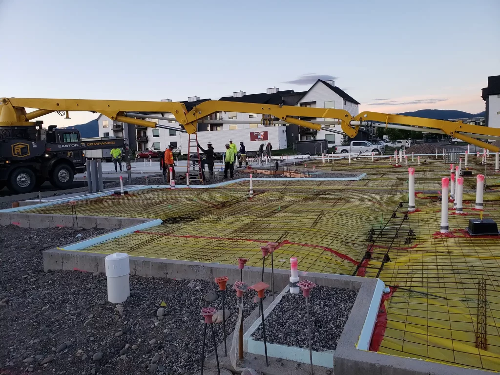 Construction workers laying concrete at the Enterprise Apartments engineering project.